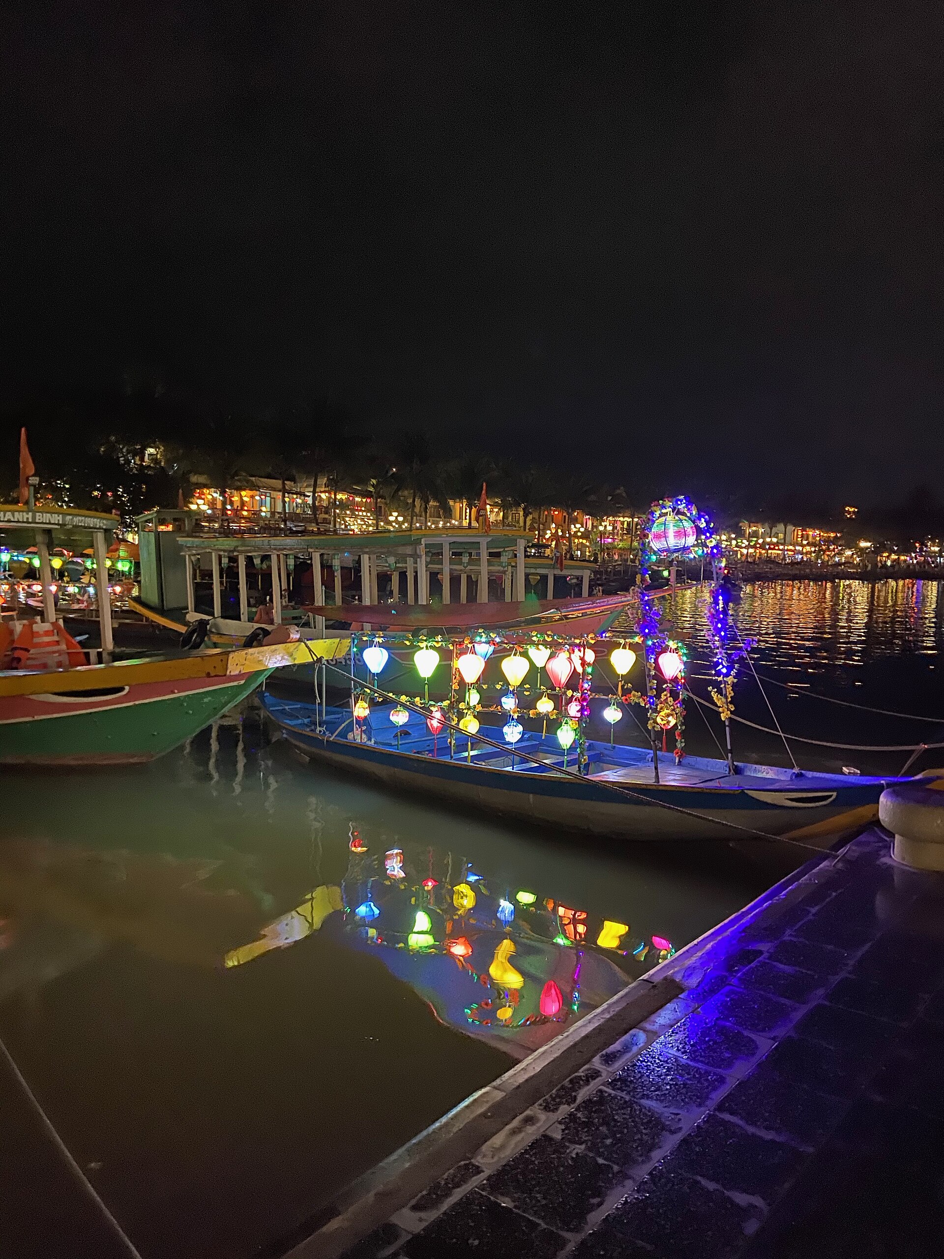 Lantern-lit old town of Hoi An at dusk, reflected in the Hoai River